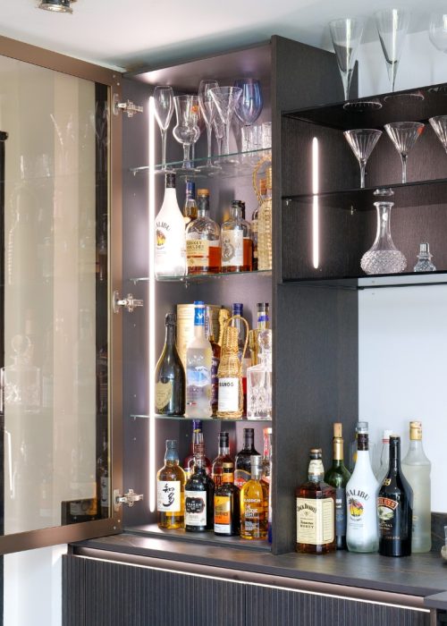 Open neoLodge bar cabinet with backlit shelving, drinks and glassware, Derby