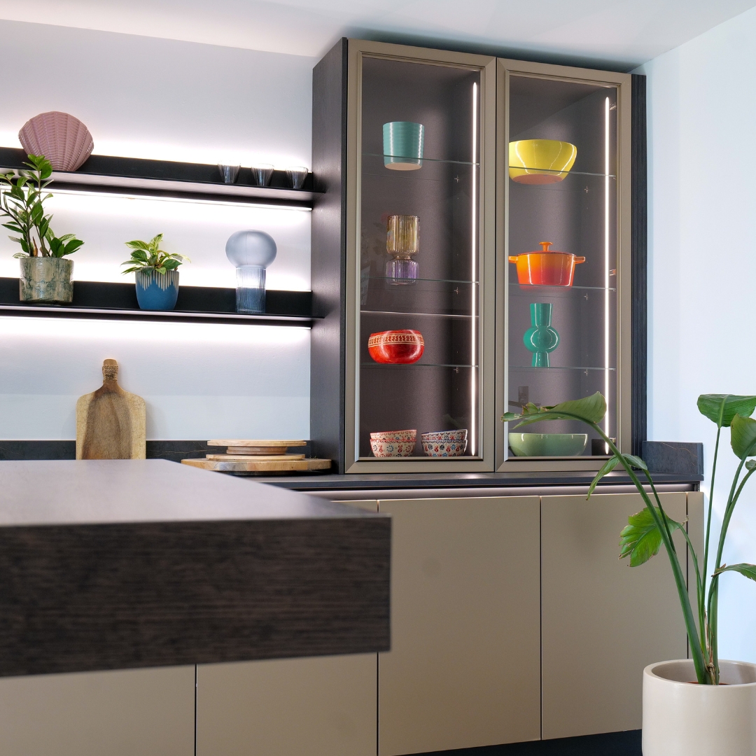 Backlit glass display cabinet with Le Creuset cookware and African pottery, neoLodge kitchen, Derby
