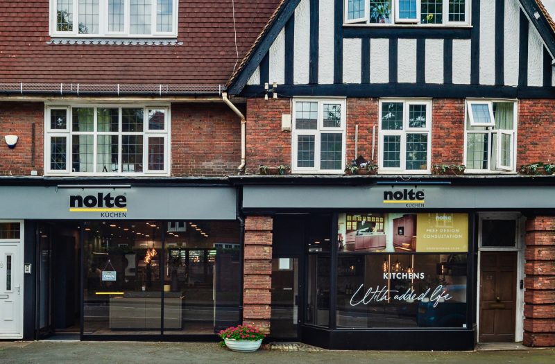Exterior of the Nolte Kitchens Amersham kitchen showroom with Nolte Küchen signage and contemporary kitchen displays visible through the windows.