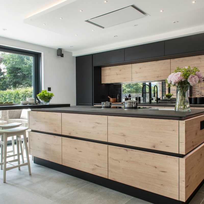 Nolte Pure black and Artwood Rustic Wild Oak kitchen with dark quartz worktop and island