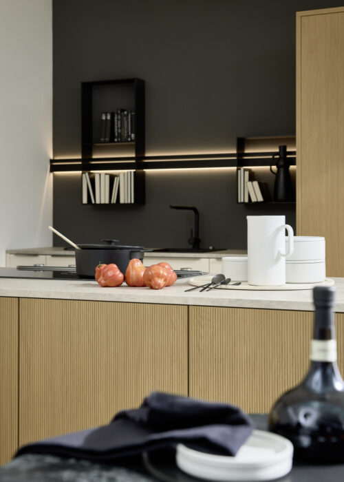 Fluted wood kitchen by Nolte Kitchens UK in Crema finish, with motionline organisation system