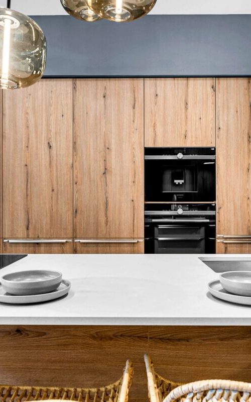 Nolte Manhattan kitchen in volcanic oak melamine finish with handleless MatrixArt design, open shelving, illuminated display cabinet and large kitchen island