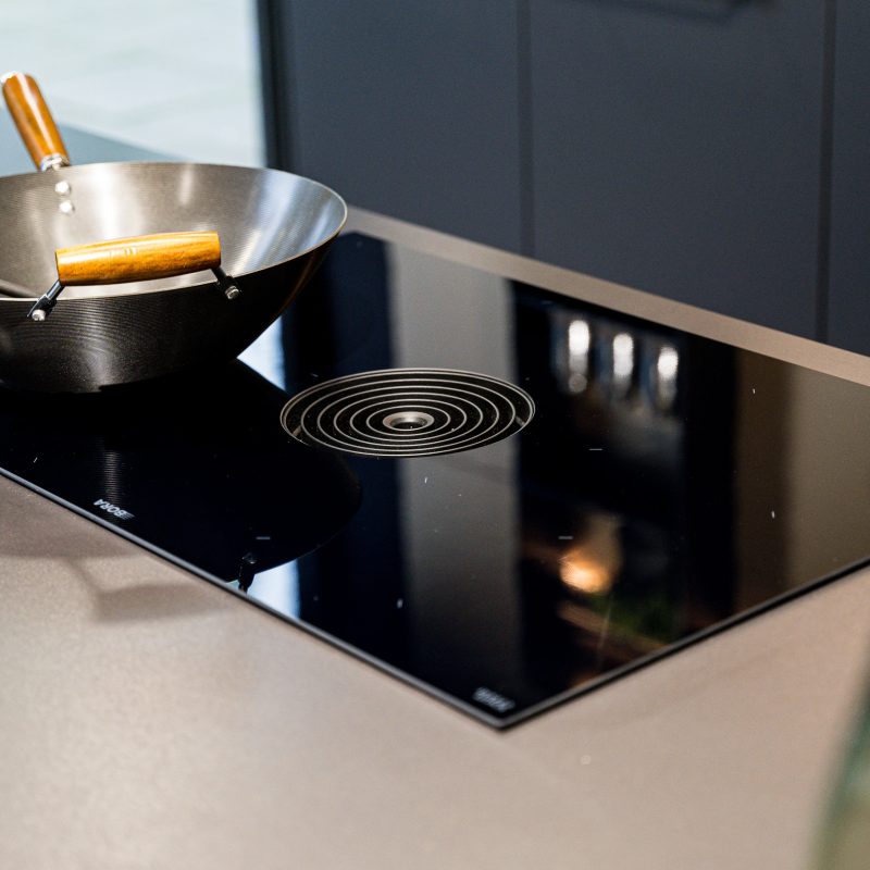 BORA Cooktop Extractor System in a neoPure kitchen display at the Nolte Wilmslow showroom, with a wok resting on the cooking zone.