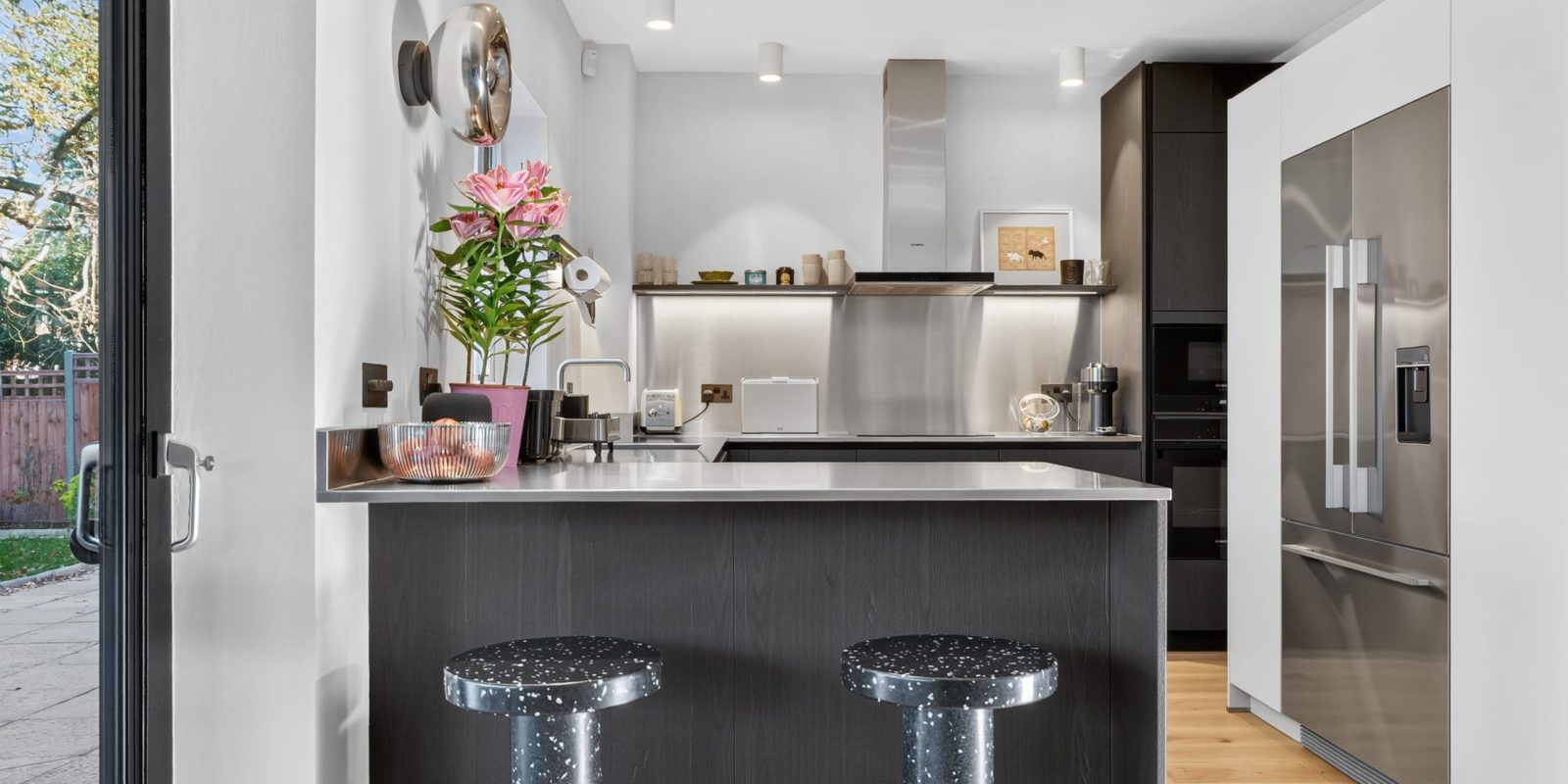 Modern Black, wood-effect kitchen installed by Nolte in Westminster