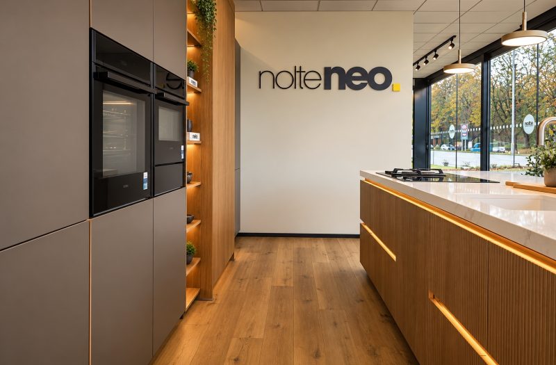 nolteneo display at the Nolte Wakefield showroom with built-in ovens, open oak shelving and a fluted neoLine oak island